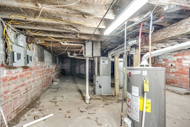 basement with gas water heater, brick wall, heating unit, and electric panel