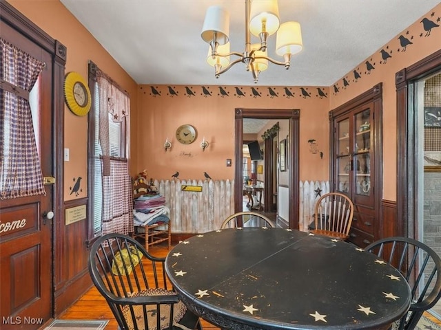 dining space with light wood-type flooring and a chandelier