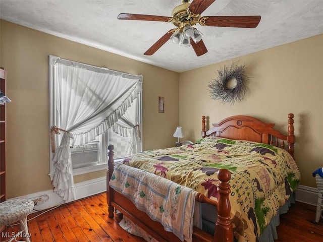 bedroom featuring wood-type flooring and ceiling fan