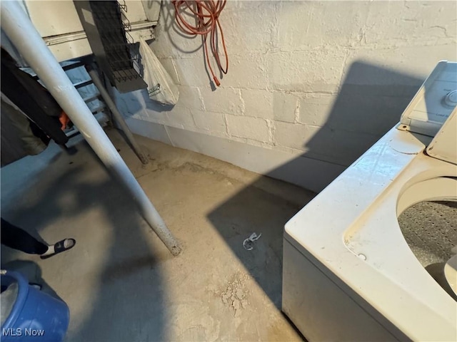 room details featuring washer / clothes dryer and concrete floors