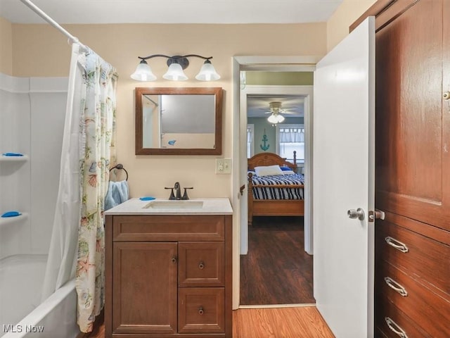 bathroom featuring shower / bath combination with curtain, vanity, and hardwood / wood-style floors