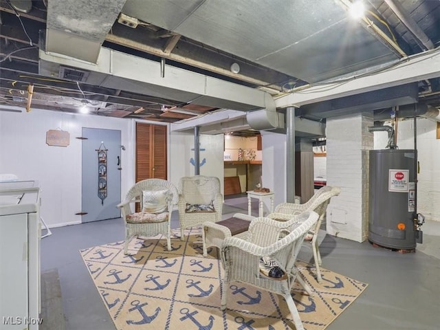 basement featuring water heater and washing machine and clothes dryer