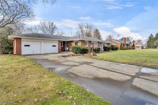 single story home featuring a garage and a front yard