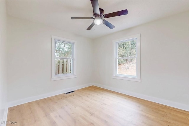 spare room with ceiling fan, plenty of natural light, and light hardwood / wood-style floors