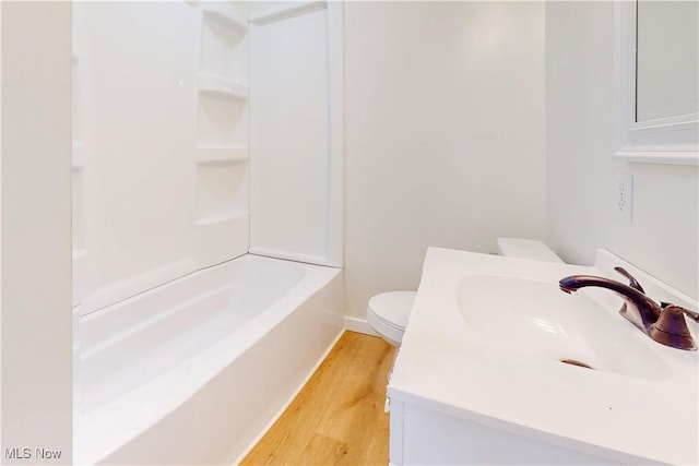 full bathroom featuring shower / tub combination, wood-type flooring, toilet, and vanity