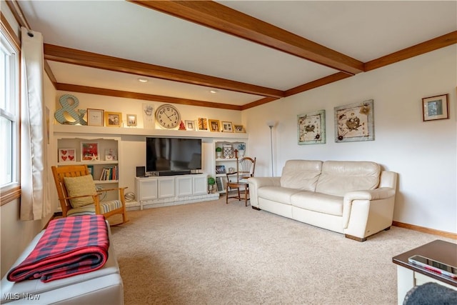 living room featuring beam ceiling, built in features, and carpet