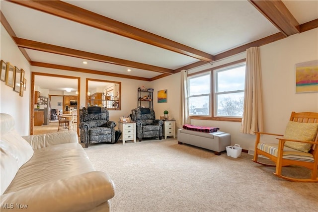 carpeted living room featuring beamed ceiling