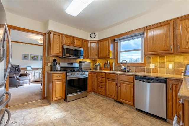 kitchen featuring sink, backsplash, and stainless steel appliances