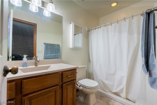 bathroom with vanity, tile patterned flooring, and toilet