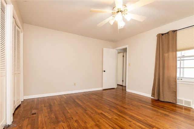 unfurnished bedroom with ceiling fan and wood-type flooring