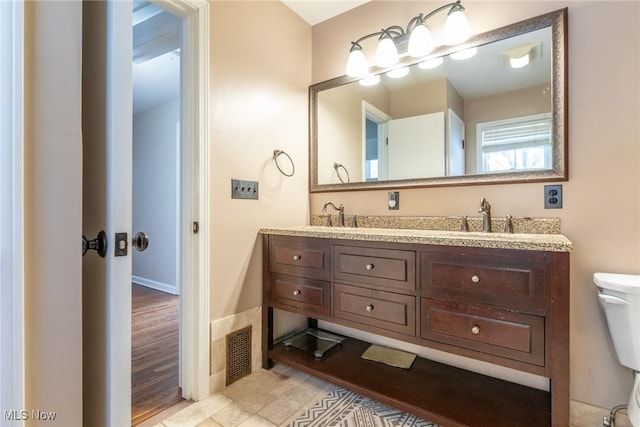 bathroom with vanity and toilet