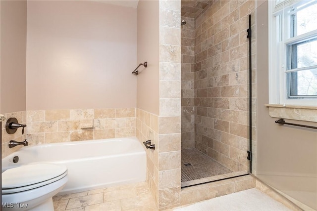 bathroom featuring shower with separate bathtub, tile patterned floors, and toilet