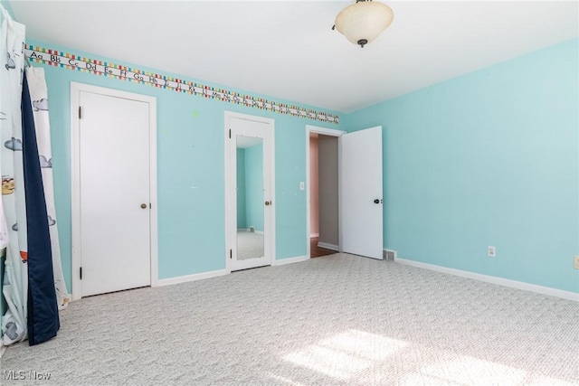 unfurnished bedroom with carpet floors