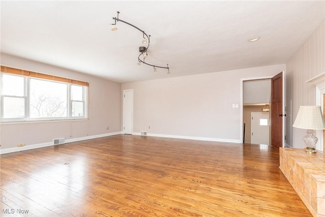 spare room featuring light wood-type flooring