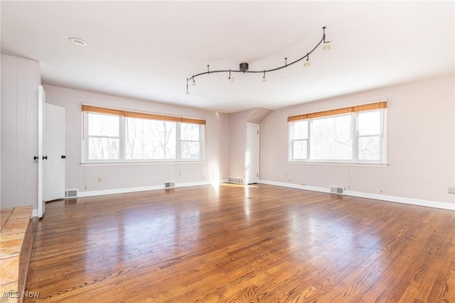 unfurnished room featuring wood-type flooring and rail lighting