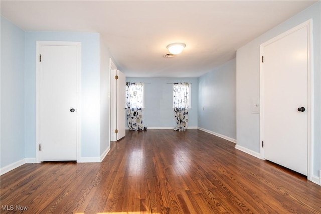 spare room featuring dark wood-type flooring