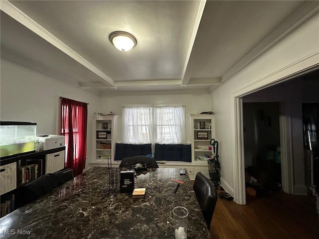 interior space featuring dark stone counters, a kitchen bar, and hardwood / wood-style floors