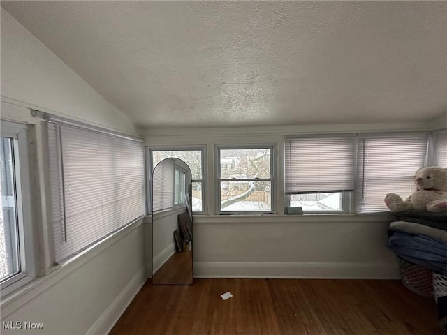 sunroom / solarium featuring vaulted ceiling