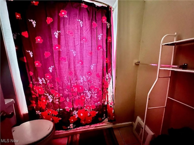 bathroom featuring tile patterned floors and toilet