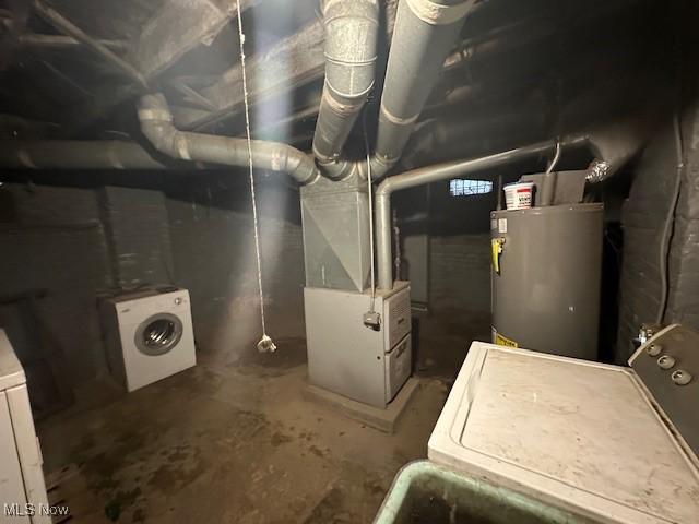 utility room featuring heating unit, washer / dryer, and gas water heater