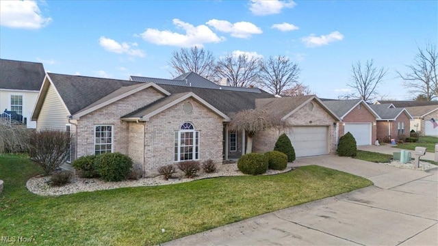 single story home featuring a garage and a front lawn