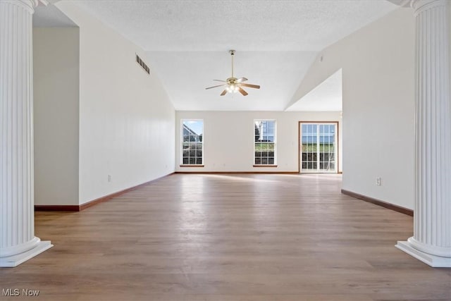 unfurnished living room featuring ceiling fan and ornate columns