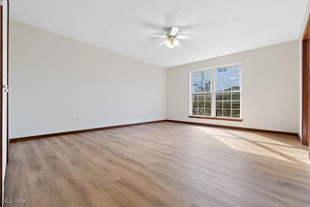 spare room featuring light hardwood / wood-style flooring and ceiling fan