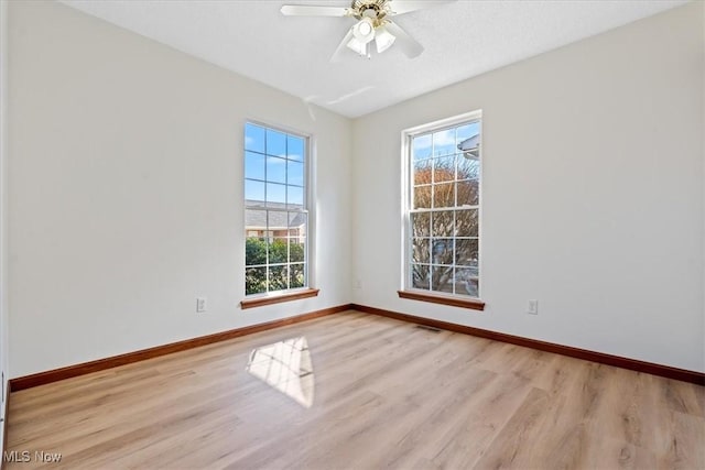 spare room with ceiling fan and light wood-type flooring