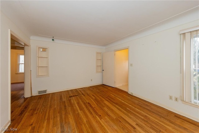 spare room featuring wood-type flooring