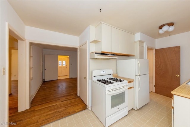 kitchen featuring white cabinets, white appliances, and light hardwood / wood-style floors