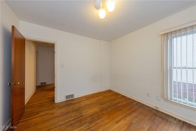 spare room with hardwood / wood-style floors