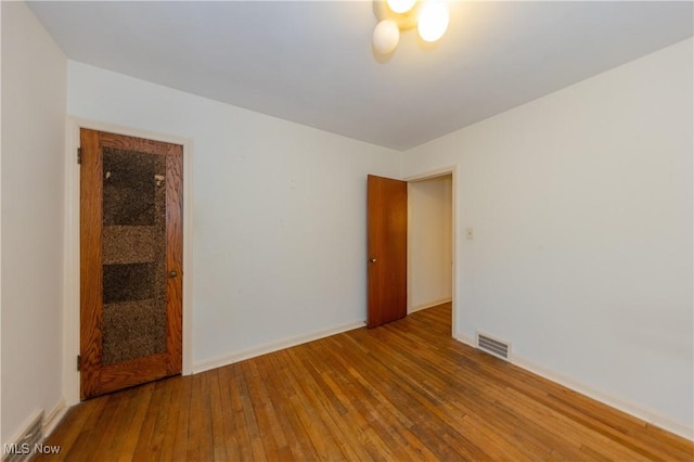 empty room featuring wood-type flooring