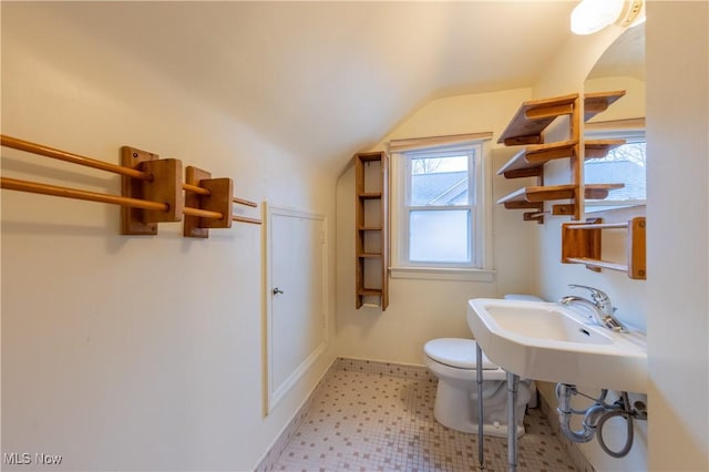 bathroom with lofted ceiling and toilet