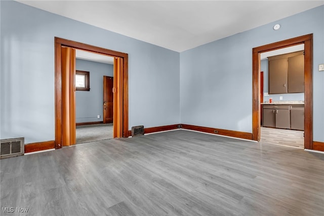 spare room featuring light hardwood / wood-style flooring