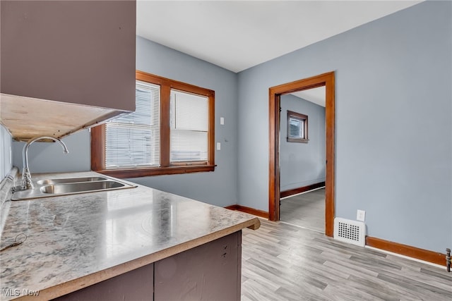 kitchen featuring sink and light wood-type flooring