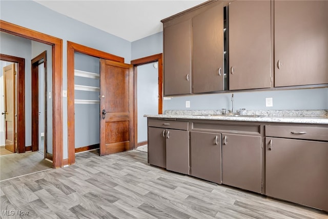 kitchen with sink and light hardwood / wood-style floors