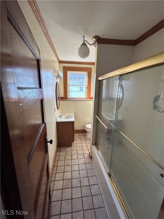 bathroom featuring vanity, tile patterned floors, ornamental molding, and toilet