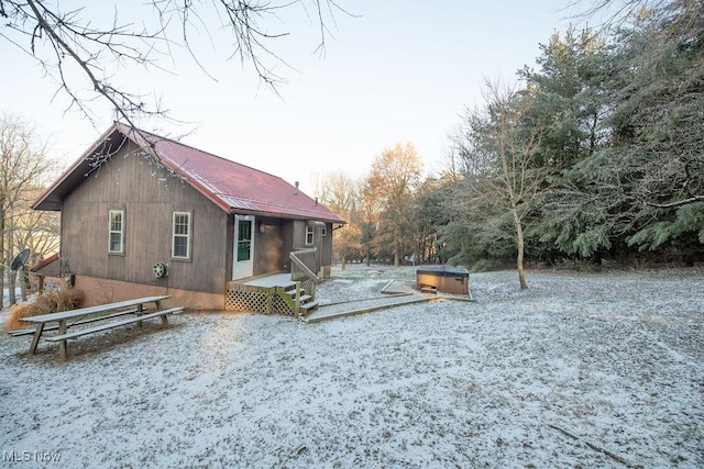 back of house featuring a hot tub