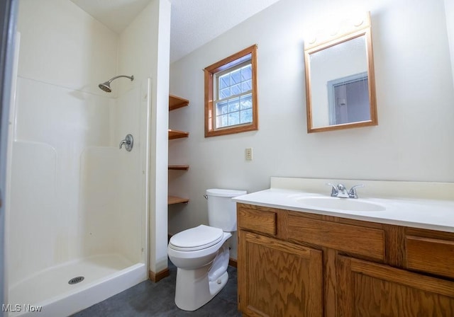 bathroom with vanity, toilet, and walk in shower