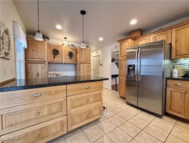 kitchen featuring decorative backsplash, stainless steel fridge, hanging light fixtures, and light tile patterned floors