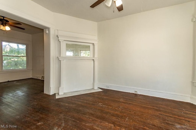 empty room with dark wood-type flooring and ceiling fan