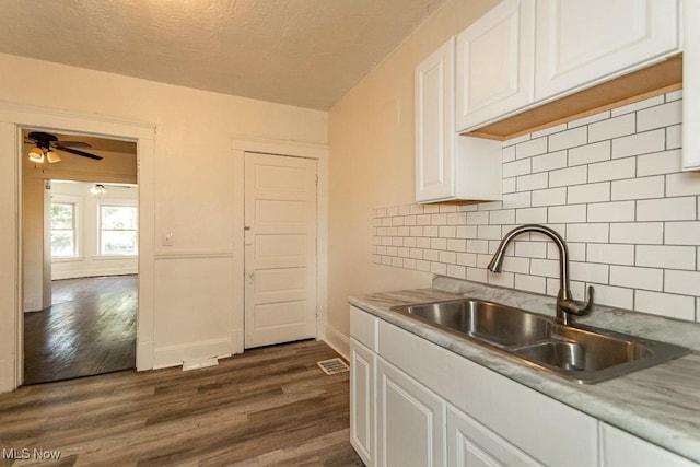 kitchen featuring white cabinetry, sink, dark hardwood / wood-style flooring, and ceiling fan