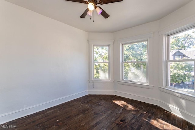 unfurnished room with ceiling fan and dark hardwood / wood-style floors