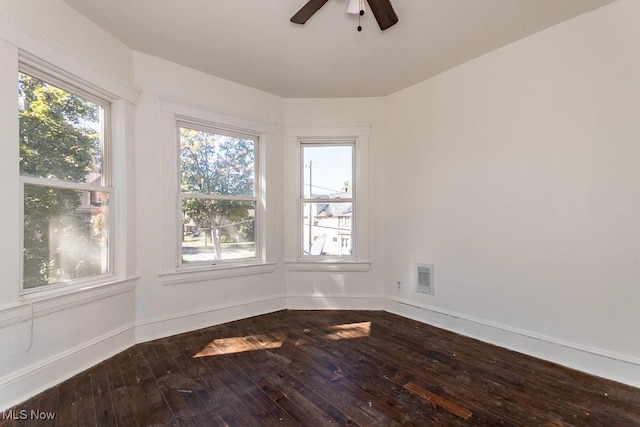 unfurnished room with wood-type flooring, plenty of natural light, and ceiling fan