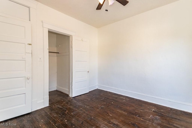 unfurnished bedroom with ceiling fan, dark hardwood / wood-style floors, and a closet