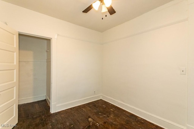 unfurnished bedroom with ceiling fan, dark hardwood / wood-style flooring, and a closet