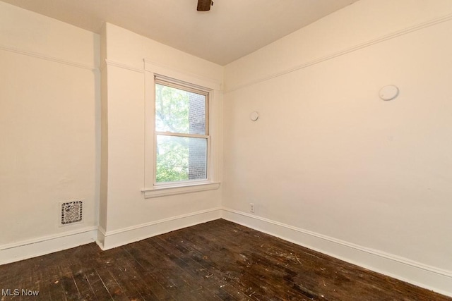 spare room featuring dark wood-type flooring