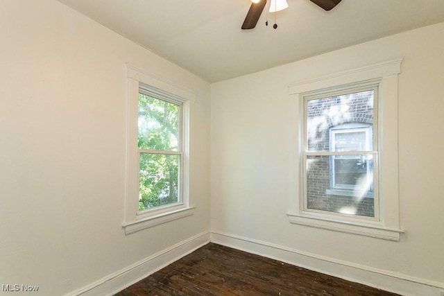 unfurnished room with dark wood-type flooring and ceiling fan