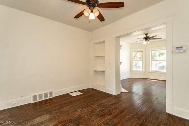 unfurnished living room with ceiling fan, dark hardwood / wood-style floors, and built in features