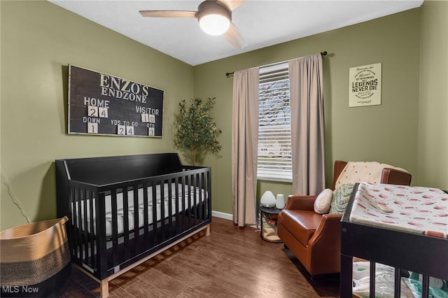 bedroom with dark hardwood / wood-style floors and ceiling fan